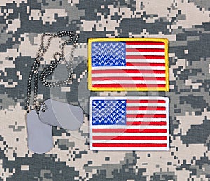 Small USA flag patches and ID tags on military battle dress uniform