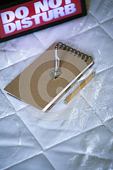 Small vacuum cleaner notepad pencil do not disturb text bed nobody