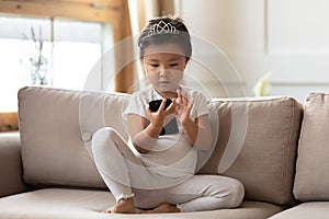 Small Vietnamese girl play use smartphone gadget at phone