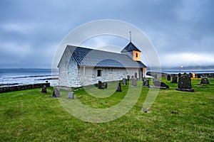 Small village church with cemetery in Kirkjubour, Faroe Islands, Denmark