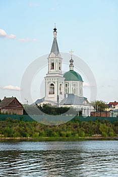 A small village church on a high hill. Church on the banks of the river.