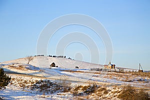 A small village Church on a hill at sunset.