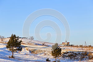 A small village Church on a hill at sunset.