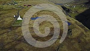 Small village church in Saksun and a nearby lake located on the island of Streymoy, Faroe Islands, Denmark. Shooting a