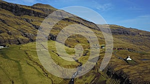 Small village church in Saksun and a nearby lake located on the island of Streymoy, Faroe Islands, Denmark. Shooting a