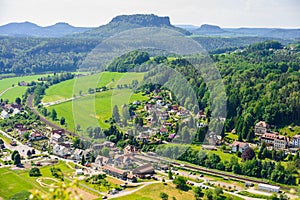 Small village and Elbe river band in front of Bastei sandstone rocks in Saxon Switzerland, Dresden, Germany