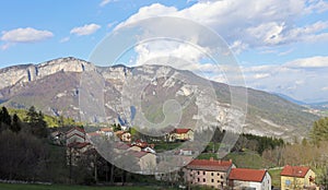 small village with a few houses surrounded by mountains