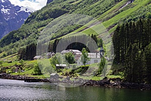 Small village houses in the nature of narrow Fjord and a lake in Aurland in Vestland county, Norway