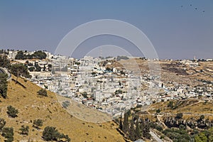 Small village and the Israeli West Bank barrier or wall - separation barrier on the West Bank in Israel. View from Montefiore