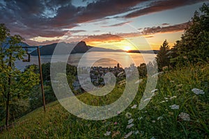 A small village on the lake during a sunset