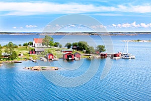 Small village with red buildings in Finnish archipelago photo