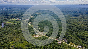 Small village with road at tropical forest and mountains near Gunung Mulu national park. Borneo. Sarawak.