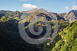 Small village under the mountains with green forest