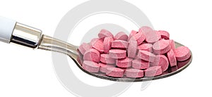 Small vitamin B12 tablets on a spoon