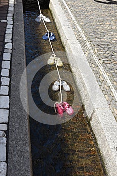 A small water-filled runnels or formalized rills called Freiburg BÃÂ¤chle with colorful water shoes inside. photo
