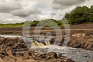 A small waterfall and bedrock exposed due to Earlstoun Dam due to drained