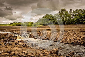 A small waterfall and bedrock exposed due to Earlstoun Dam due to drained