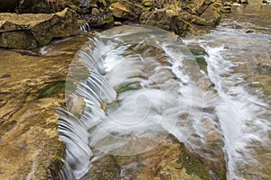 A small waterfall and clear water on the river Brestova