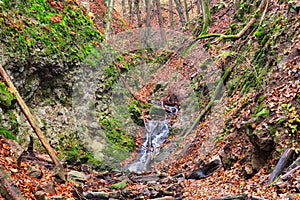 Small waterfall in creek in Turovska roklina gorge during autumn in Kremnicke vrchy mountains