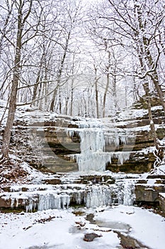 Small waterfall at Creve Couer Park frozen during a snowstorm photo