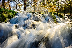 Small waterfall on famous landmark Mlincici near Jajce on Plivsko Lake in Bosnia and Herzegovina. Long exposure waterfall photo