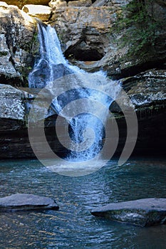 Small waterfall flowing down a rockface in the forest