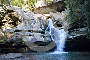 Small waterfall flowing down a rockface in the forest