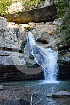 Small waterfall flowing down a rockface in the forest