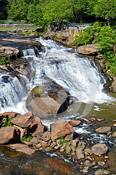 Small waterfall flowing down a rockface in the forest