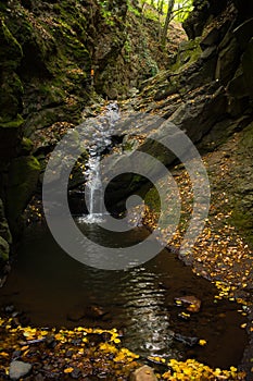 Small waterfall inside a narrow rocky canyon