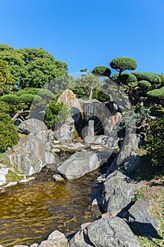 A small waterfall in a Japanese park in Buenos Aires. vertically