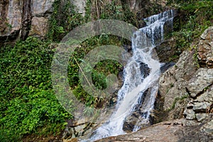 Small waterfall in the jungle on the rocks