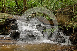 Small waterfall in the jungle on the rocks