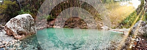 Small waterfall in the jungle with turquoise water, panorama