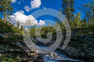 Small waterfall on a mountain stream among the rocks