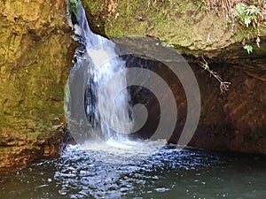 Small waterfall over rocks on Greaves Creek on the Grand Canyon Walking Track