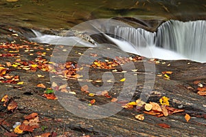 A small waterfall over smooth rocks