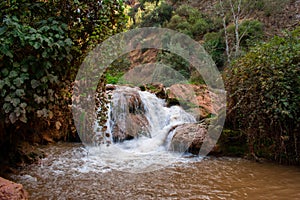 Small waterfall on river in Atlas Mountains, Morocco. Water stream in Forest.