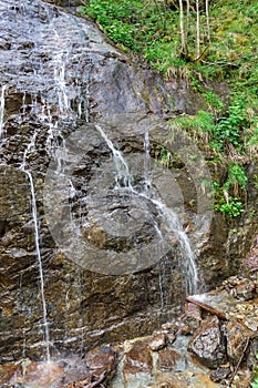 Small waterfall on the rocks in the Alps