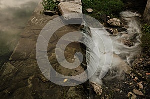 Small waterfall with running water, silk effect, natural waterfall landscape