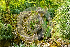 The small waterfall and stone bridge, Quinta da Regaleira garden, Sintra, Portugal
