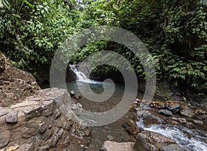 Small waterfall and swimming area in Costa Rica rainforest