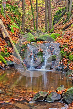 Small waterfall in Turovska roklina gorge during autumn in Kremnicke vrchy mountains