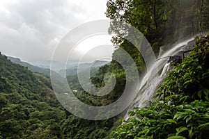 Small waterfall and view over lush forest in Taipei