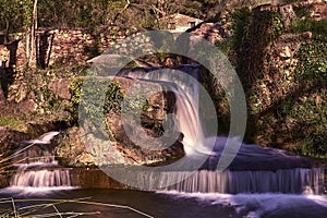 Small waterfalls in a mountain stream on a sunny day