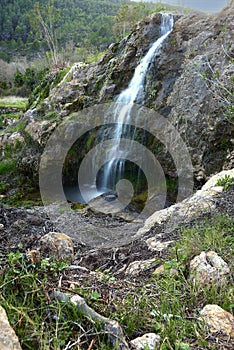 Small waterfalls in a mountain stream on a sunny day