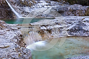 Small waterfalls of pure water at the Brenton Cadins, in the valley of Mis, Belluno