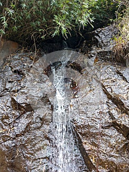 Small waterfalls from the rock in western ghats mountain,Ooty, Taminadu