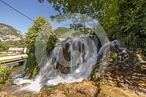 Small waterfalls on Una river, close to Martin Brod, Bosnia, on a summer day. Beautiful green river in a valley, with cascades and photo