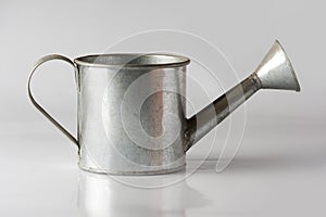 Small watering can on the white background